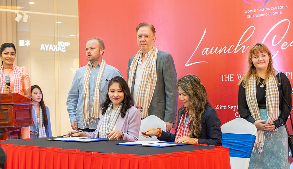Kim Tan Tol, CEO of Grow4Growth, and Sarvinoz Nuritdinova, CEO of B2B Cambodia, sign an MoU to officially launch The Women Shaping Cambodia show